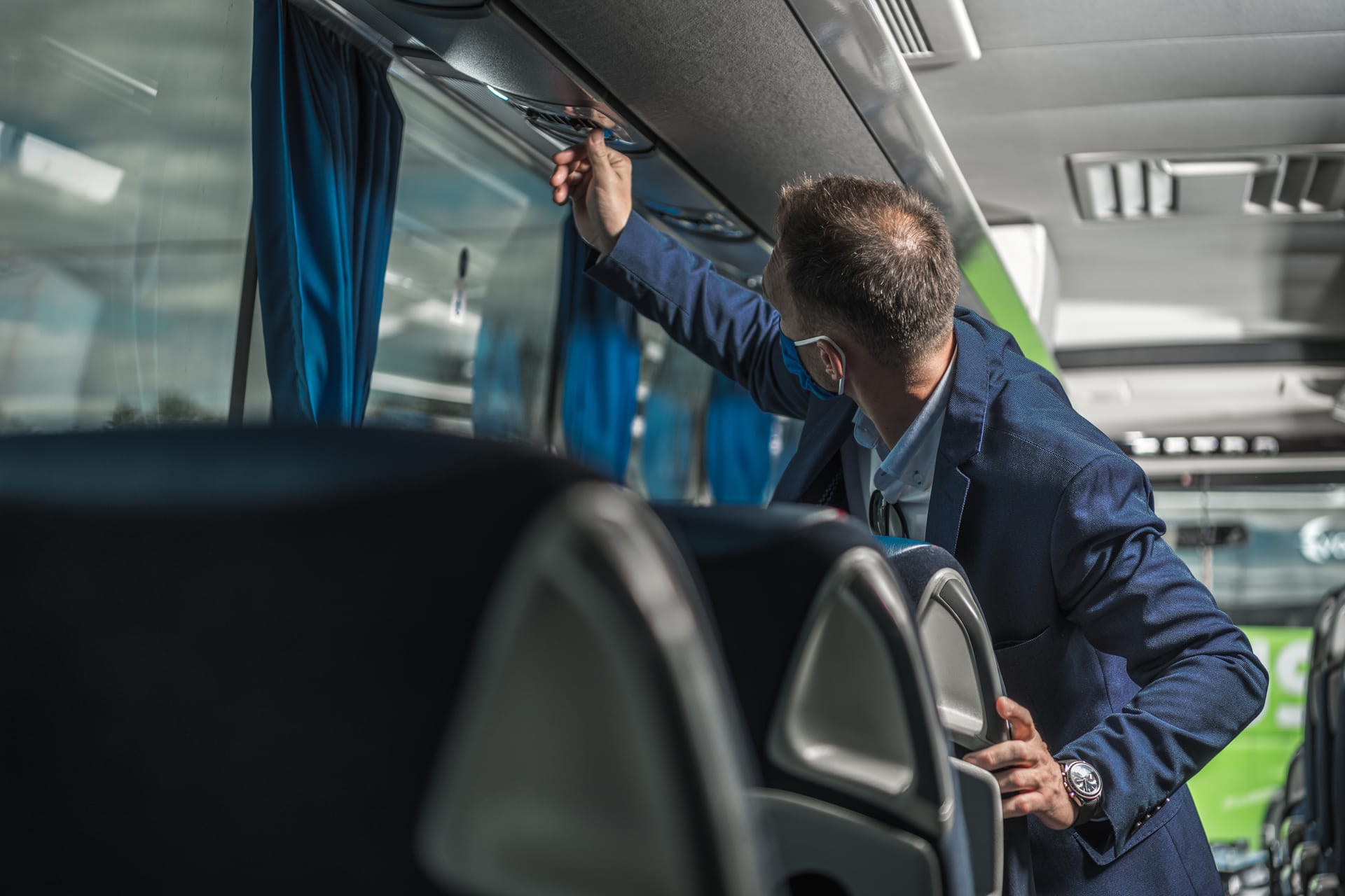 Driver checking vehicle systems in cabin